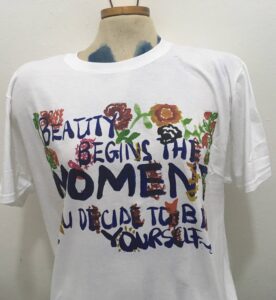 T-shirt on mannequin with the typography design "Beauty begins the moment you decide to be yourself-Coco Chanel"
