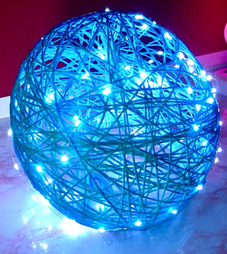 Light blue yarn-spun globe lamp