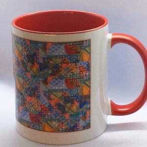 Photo of white ceramic mug with colored interior and a colorful print on the exterior