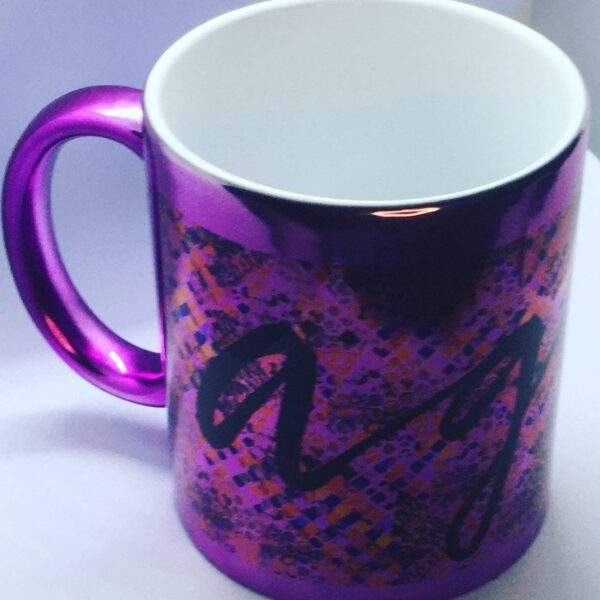 Photo of metallic ceramic mug with a colorful print