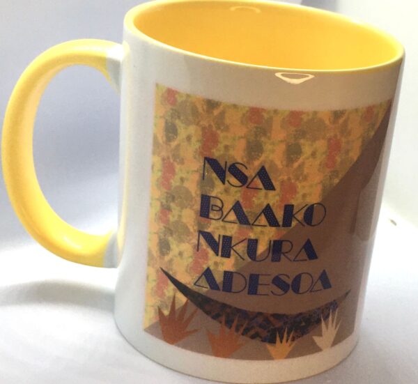 Photo of a white ceramic mug with a yellow interior and handle and a typography design on the exterior