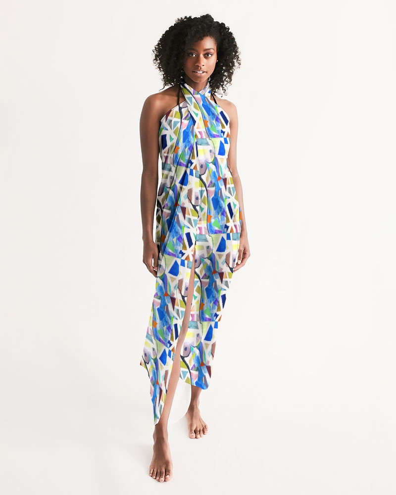 Model wearing a sarong with an abstract art print design.