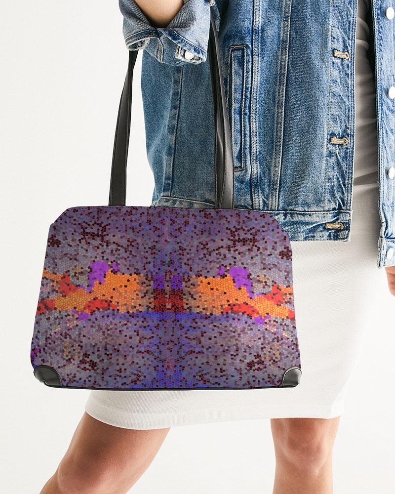 Photo of a model holding a bag with a print design 